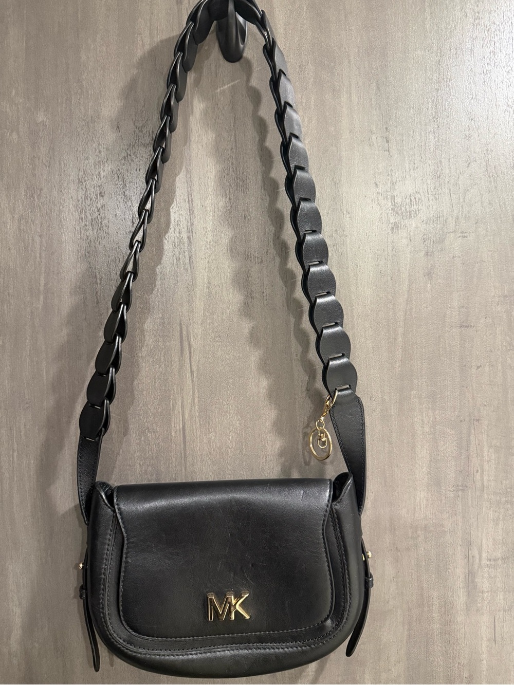 ⁠MICHAEL KORS Jolene black leather saddle bag with interlocking woven strap